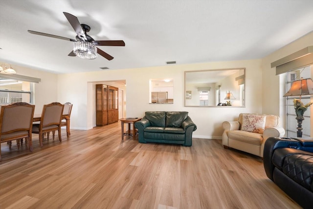 6282 41st Ave N, Saint Petersburg, FL 33709 - living area with ceiling fan, baseboards, and light wood-style floors