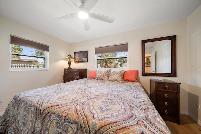 6282 41st Ave N, Saint Petersburg, FL 33709 - bedroom featuring baseboards, wood finished floors, multiple windows, and a ceiling fan