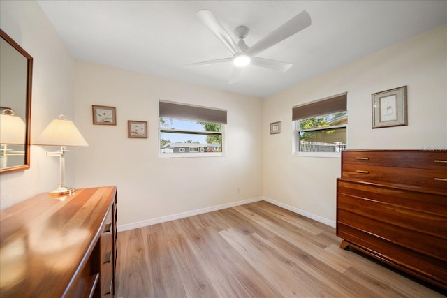6282 41st Ave N, Saint Petersburg, FL 33709 - unfurnished bedroom featuring multiple windows, light wood-style flooring, baseboards, and a ceiling fan