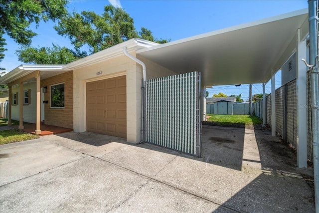 6282 41st Ave N, Saint Petersburg, FL 33709 - view of home's exterior with concrete driveway, a carport, and a garage