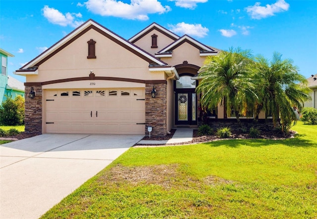 2350 126th Dr E, Parrish, FL 34219 - view of front of house with stone siding, stucco siding, a front yard, driveway, and an attached garage