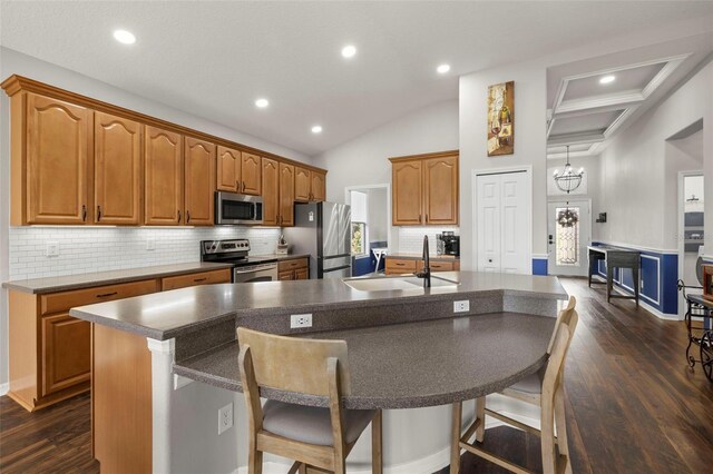 2350 126th Dr E, Parrish, FL 34219 - kitchen featuring stainless steel appliances, a kitchen island with sink, dark wood-style flooring, backsplash, and a breakfast bar