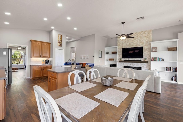2350 126th Dr E, Parrish, FL 34219 - dining room featuring a ceiling fan, lofted ceiling, a fireplace, dark wood finished floors, and built in shelves