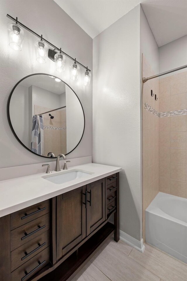 2350 126th Dr E, Parrish, FL 34219 - full bathroom featuring vanity, shower / bathtub combination with curtain, and wood finished floors