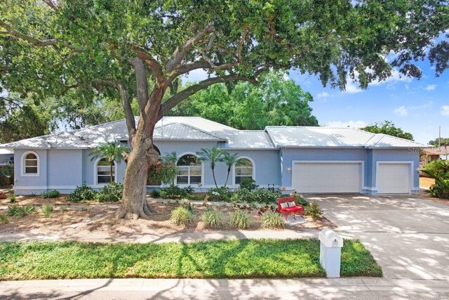613 Sportsman Park Dr, Seffner, FL 33584 - ranch-style house with a garage, stucco siding, and concrete driveway