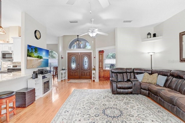 613 Sportsman Park Dr, Seffner, FL 33584 - living room featuring a ceiling fan, light wood-style flooring, and a high ceiling