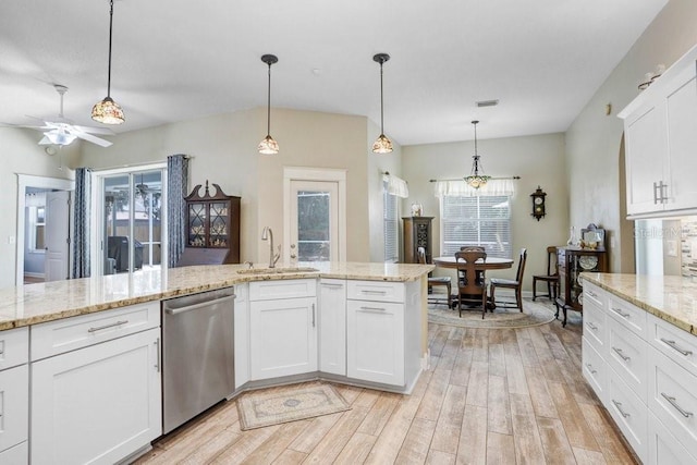 613 Sportsman Park Dr, Seffner, FL 33584 - kitchen with stainless steel dishwasher, a sink, ceiling fan, and light wood-style floors