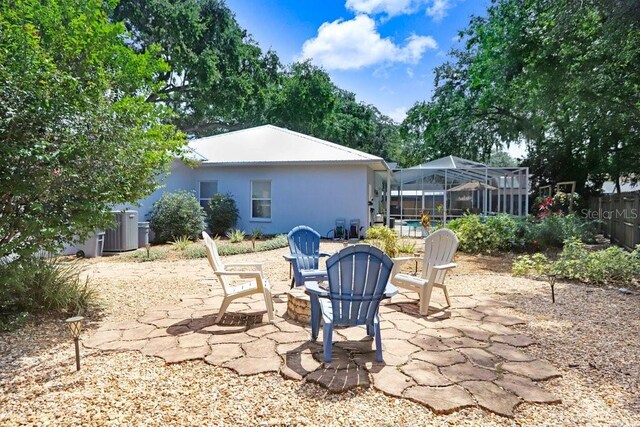 613 Sportsman Park Dr, Seffner, FL 33584 - view of patio / terrace with a fire pit, glass enclosure, and central AC