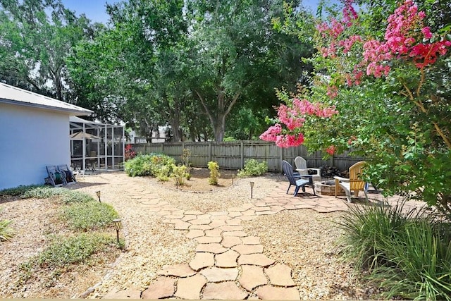 613 Sportsman Park Dr, Seffner, FL 33584 - fenced backyard featuring a fire pit, a lanai, and a patio