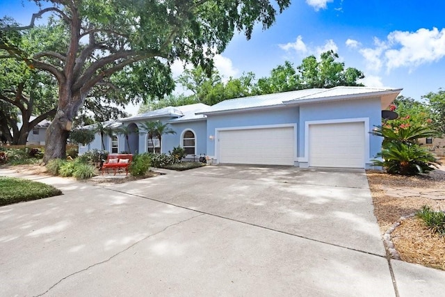 613 Sportsman Park Dr, Seffner, FL 33584 - single story home with stucco siding, an attached garage, driveway, and metal roof