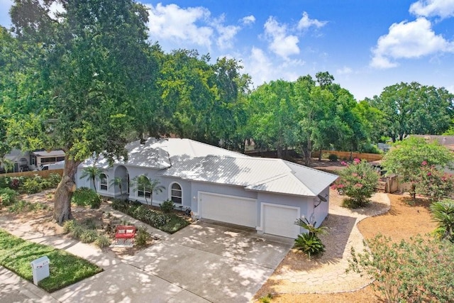 613 Sportsman Park Dr, Seffner, FL 33584 - view of front facade featuring an attached garage, stucco siding, concrete driveway, and metal roof