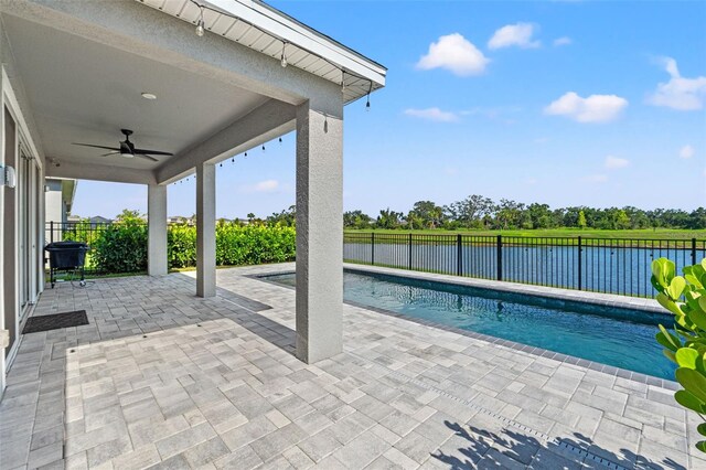 6123 Golden Nettle Dr, Apollo Beach, FL 33572 - view of pool featuring ceiling fan, a patio, a fenced backyard, and a water view