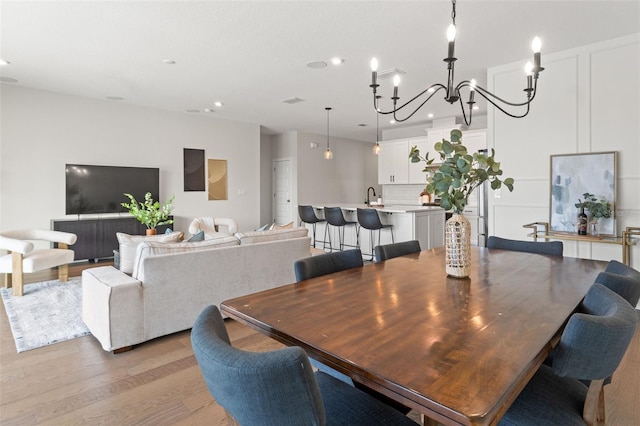 6123 Golden Nettle Dr, Apollo Beach, FL 33572 - dining room with light wood finished floors, recessed lighting, and a chandelier