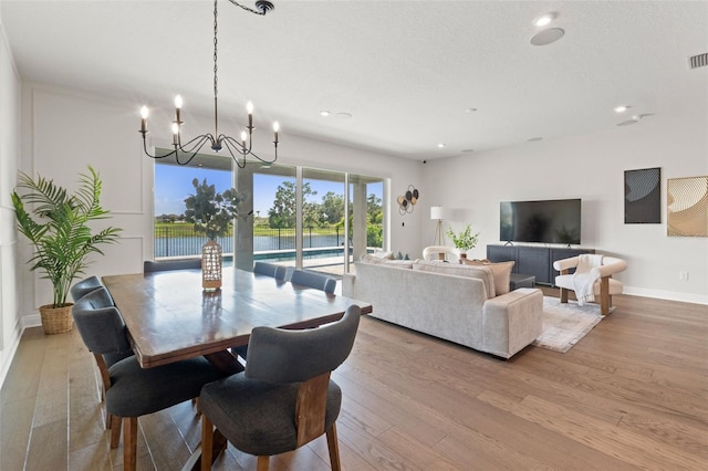 6123 Golden Nettle Dr, Apollo Beach, FL 33572 - dining space with wood finished floors, a chandelier, recessed lighting, and baseboards