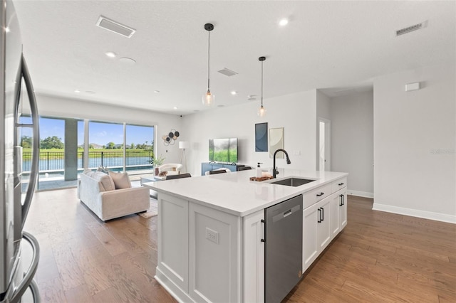 6123 Golden Nettle Dr, Apollo Beach, FL 33572 - kitchen with stainless steel appliances, open floor plan, a sink, light wood-style floors, and recessed lighting