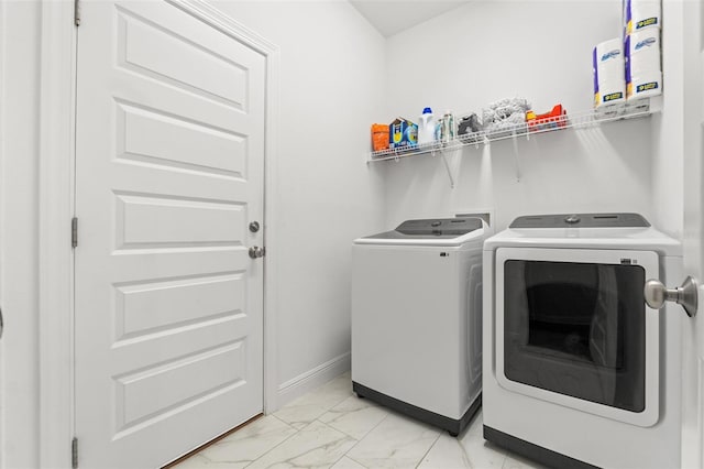 6123 Golden Nettle Dr, Apollo Beach, FL 33572 - laundry area featuring washing machine and clothes dryer, light marble finish floors, and baseboards