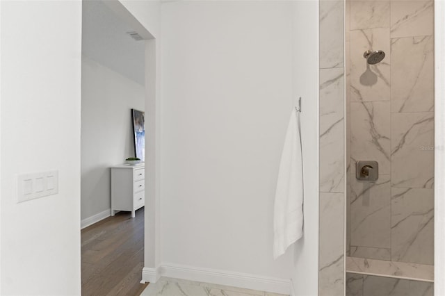6123 Golden Nettle Dr, Apollo Beach, FL 33572 - bathroom featuring a marble finish shower, marble look tiles, and baseboards