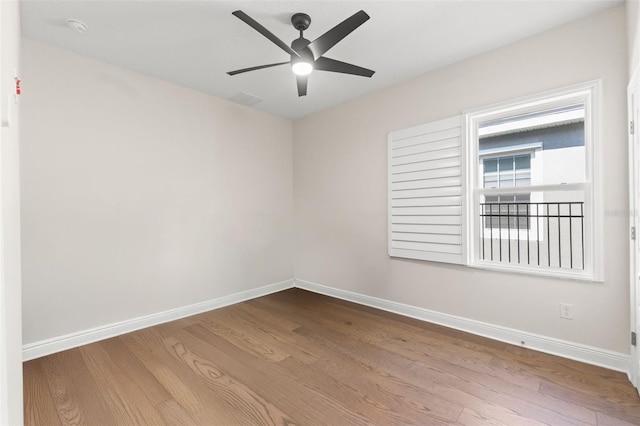 6123 Golden Nettle Dr, Apollo Beach, FL 33572 - empty room with baseboards, wood finished floors, ceiling fan, and a smoke detector