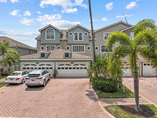 1622 Lago Vista Blvd, Palm Harbor, FL 34685 - view of front of house featuring decorative driveway, a garage, and stucco siding