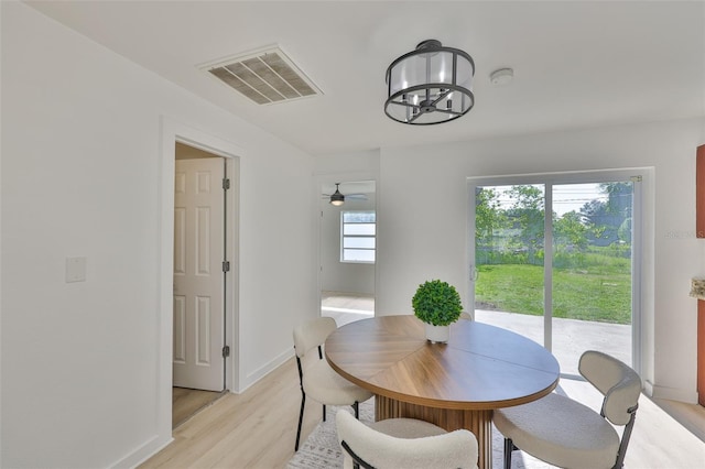 1110 Waterview Blvd E, Lakeland, FL 33801 - dining area featuring light wood finished floors, baseboards, a chandelier, and a ceiling fan
