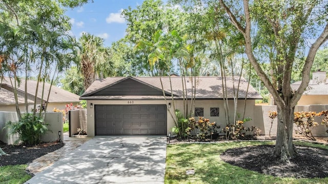 660 Channing Dr, Palm Harbor, FL 34684 - view of front facade with stucco siding, a garage, concrete driveway, and a shingled roof