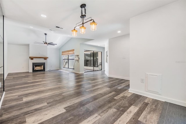 660 Channing Dr, Palm Harbor, FL 34684 - unfurnished living room with ceiling fan, wood finished floors, vaulted ceiling, a fireplace with flush hearth, and recessed lighting
