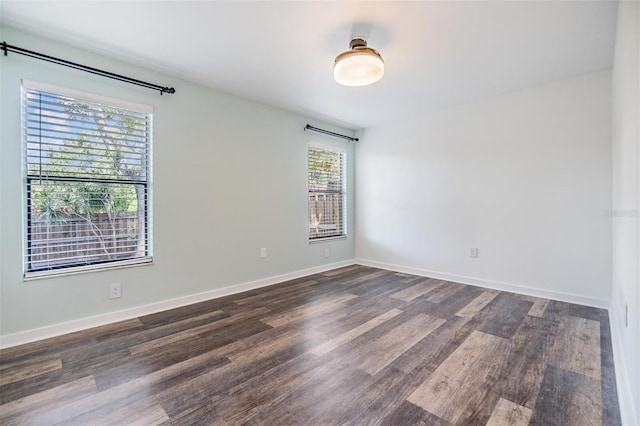 660 Channing Dr, Palm Harbor, FL 34684 - spare room with dark wood-style floors and baseboards