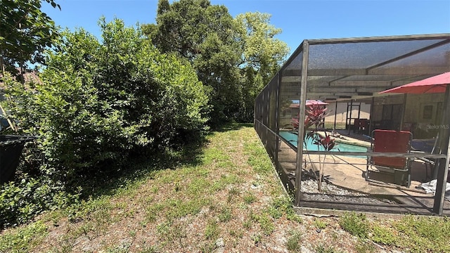 7700 Willow Brook Ct, Hudson, FL 34667 - view of yard featuring an outdoor pool, glass enclosure, and a patio area