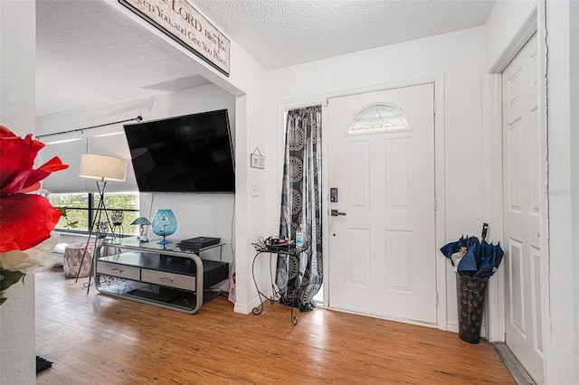 7700 Willow Brook Ct, Hudson, FL 34667 - entrance foyer with wood finished floors and a textured ceiling