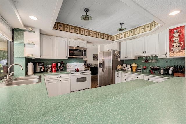 7700 Willow Brook Ct, Hudson, FL 34667 - kitchen with stainless steel appliances, white cabinets, decorative backsplash, recessed lighting, and a textured ceiling