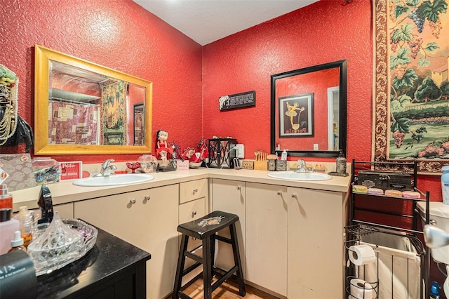 7700 Willow Brook Ct, Hudson, FL 34667 - full bathroom with a textured wall, double vanity, and wood finished floors