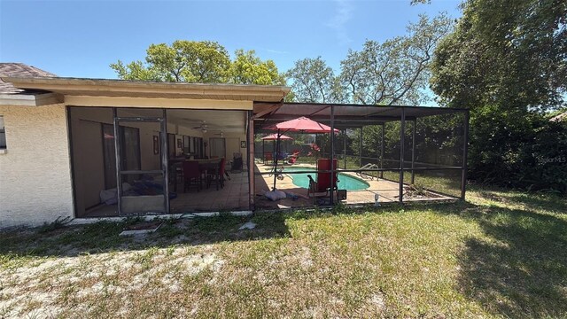 7700 Willow Brook Ct, Hudson, FL 34667 - view of green lawn with an outdoor pool, a patio area, a lanai, and a sunroom
