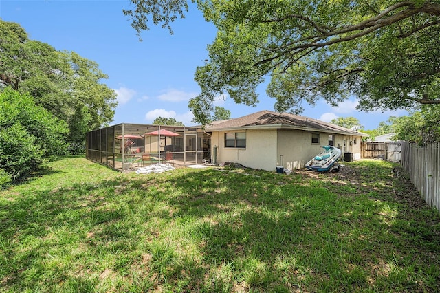 7700 Willow Brook Ct, Hudson, FL 34667 - back of house with stucco siding, a fenced backyard, and a lanai