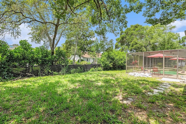 7700 Willow Brook Ct, Hudson, FL 34667 - fenced backyard featuring an outdoor pool and glass enclosure