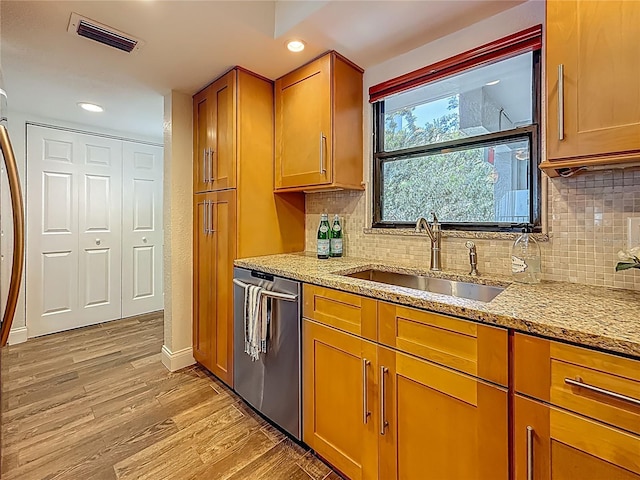 105 4th Ave NE Unit 426, Saint Petersburg, FL 33701 - kitchen with dishwasher, light wood-style floors, light stone counters, brown cabinets, and recessed lighting