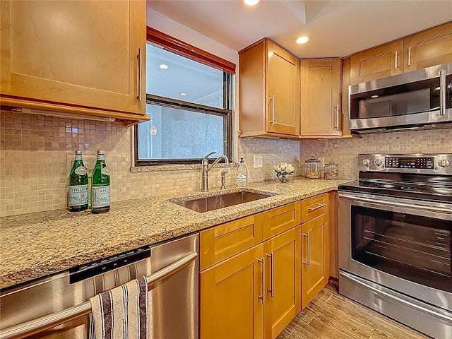 105 4th Ave NE Unit 426, Saint Petersburg, FL 33701 - kitchen featuring stainless steel appliances, decorative backsplash, light stone countertops, light wood-style floors, and recessed lighting