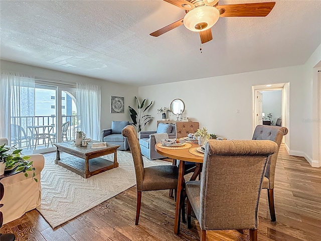 105 4th Ave NE Unit 426, Saint Petersburg, FL 33701 - dining room featuring a textured ceiling, wood finished floors, and ceiling fan
