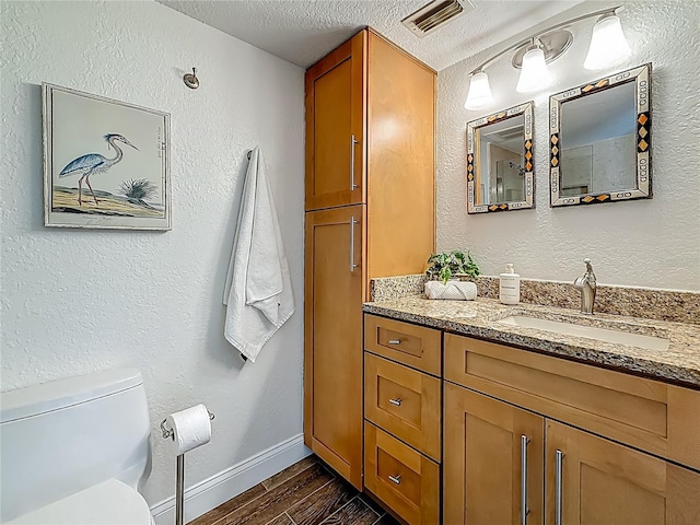 105 4th Ave NE Unit 426, Saint Petersburg, FL 33701 - bathroom featuring vanity, a textured ceiling, and wood finished floors