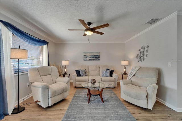 1813 Allegheny Dr, Sun City Center, FL 33573 - living area with ceiling fan, wood finished floors, a textured ceiling, ornamental molding, and baseboards