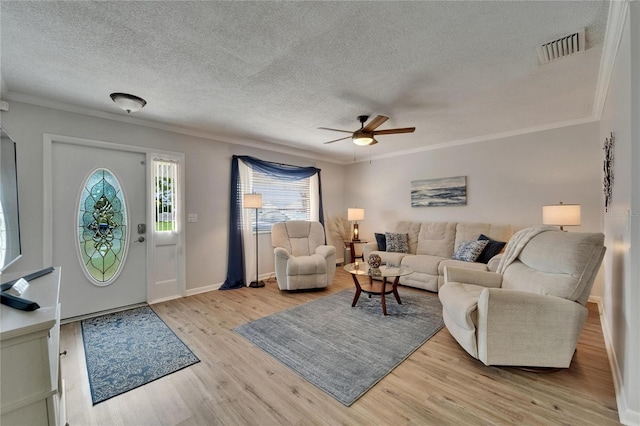 1813 Allegheny Dr, Sun City Center, FL 33573 - living room featuring crown molding, a ceiling fan, a textured ceiling, light wood finished floors, and baseboards
