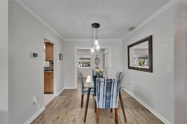 1813 Allegheny Dr, Sun City Center, FL 33573 - dining room with light wood-style flooring, baseboards, and crown molding
