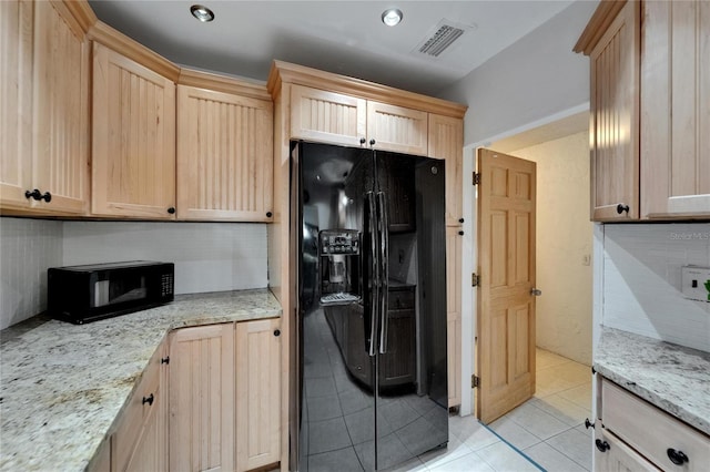 1813 Allegheny Dr, Sun City Center, FL 33573 - kitchen with black fridge with ice dispenser, light brown cabinets, light tile patterned floors, light stone countertops, and backsplash