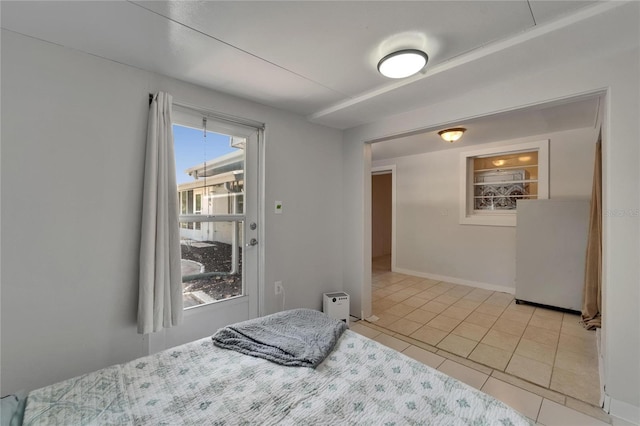 1813 Allegheny Dr, Sun City Center, FL 33573 - bedroom with light tile patterned floors, refrigerator, and baseboards