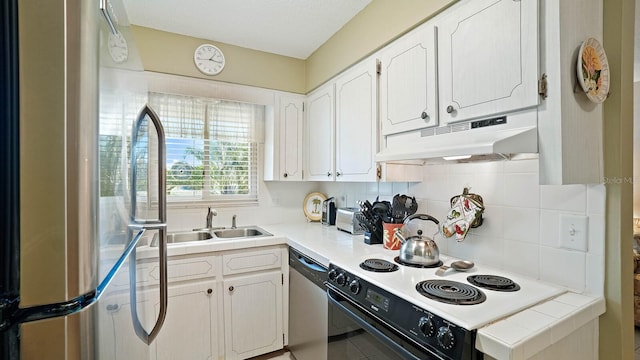 600 71st Ave Unit 16, St Pete Beach, FL 33706 - kitchen featuring under cabinet range hood, appliances with stainless steel finishes, white cabinetry, and a sink