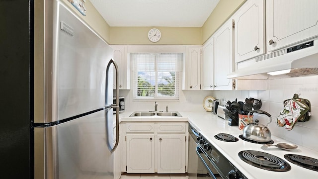 600 71st Ave Unit 16, St Pete Beach, FL 33706 - kitchen featuring freestanding refrigerator, a sink, under cabinet range hood, white electric range oven, and white cabinetry