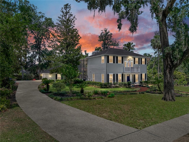 4611 Ackerly Way, Brandon, FL 33511 - view of front of home with a balcony, a yard, and driveway