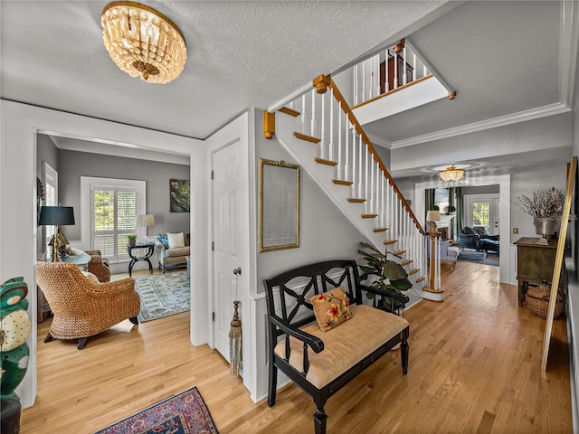 4611 Ackerly Way, Brandon, FL 33511 - entrance foyer with stairway, healthy amount of natural light, wood finished floors, a chandelier, and a textured ceiling