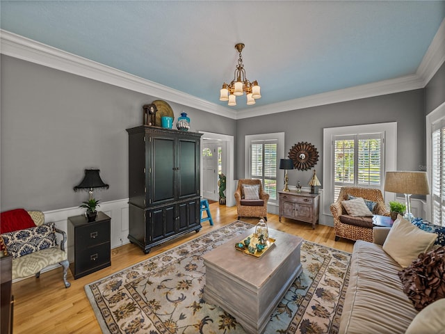 4611 Ackerly Way, Brandon, FL 33511 - living area with a chandelier, light wood-type flooring, crown molding, and wainscoting