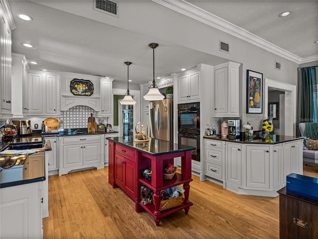 4611 Ackerly Way, Brandon, FL 33511 - kitchen featuring freestanding refrigerator, ornamental molding, dark countertops, white cabinets, and light wood-style flooring