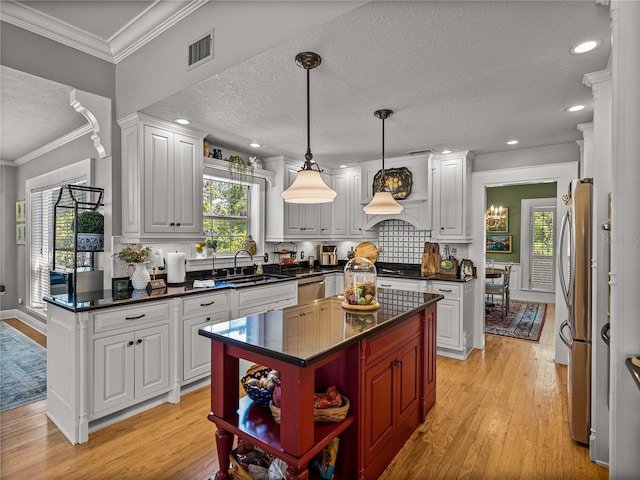 4611 Ackerly Way, Brandon, FL 33511 - kitchen with open shelves, light wood-type flooring, stainless steel appliances, a textured ceiling, and white cabinets